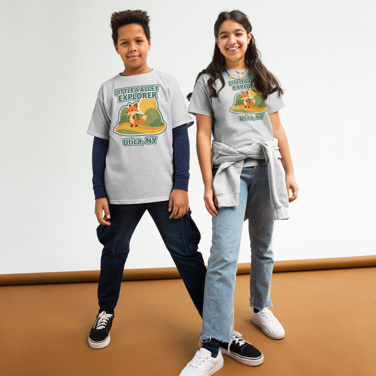 Two models wearing sport grey youth T-shirts with Little Valley Explorer fox graphic and Utica, NY lettering